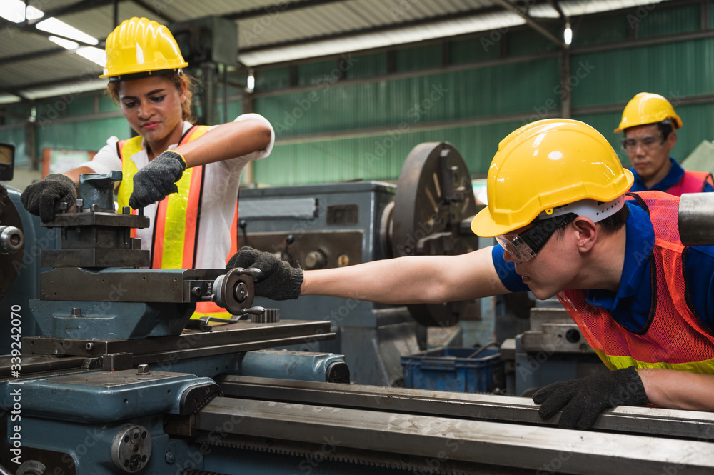 The industrial worker team is working on various projects in a large industrial factory with many equipment. The industrial worker team is working on various projects in a large industrial factory with many equipment.