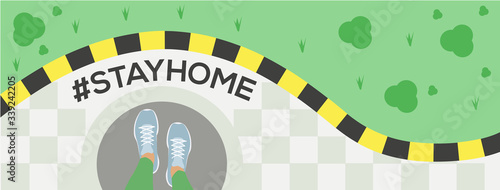 Stay at home slogan with legs in running shoes on the doorstep at exit of house in front of lawn. Protection campaign or measure from coronavirus, COVID 19. Stay home quote text, hash tag or hashtag.