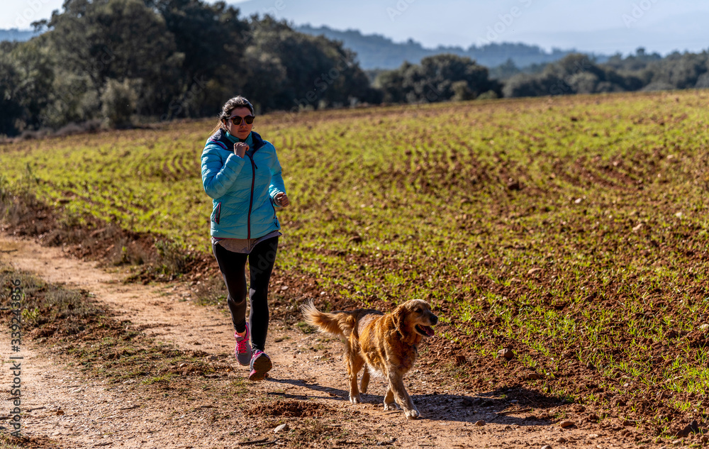 young girl running and playing sports with her dog in the wild. young girl running and playing sports with her dog in the wild.