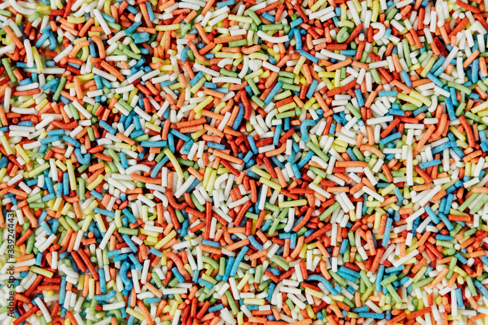Multicolored sugar sprinkles background. Decorating pastry items.