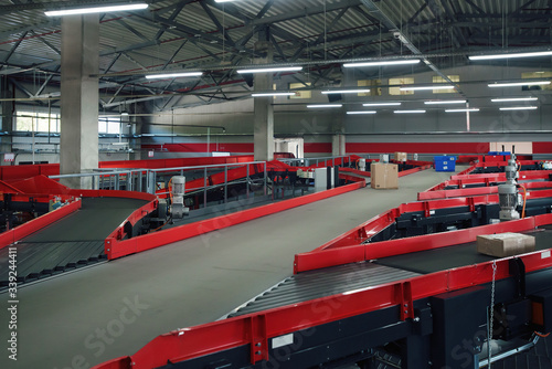 conveyor sorting belt at distribution warehouse. Distribution hub for sorting packages