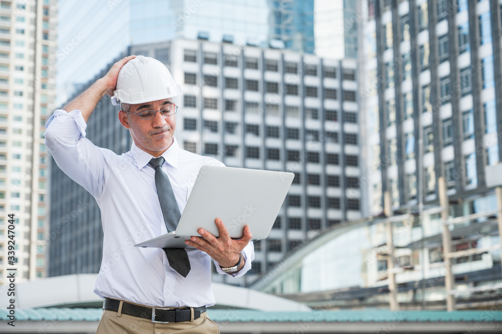 Civil engineering using laptop while working on building construction site and feeling bad with his work. Civil engineering using laptop while working on building construction site and feeling bad with his work.