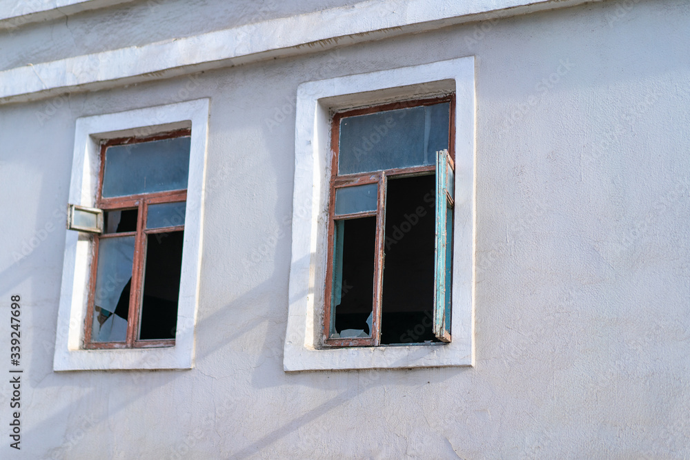 Broken glass windows in a house