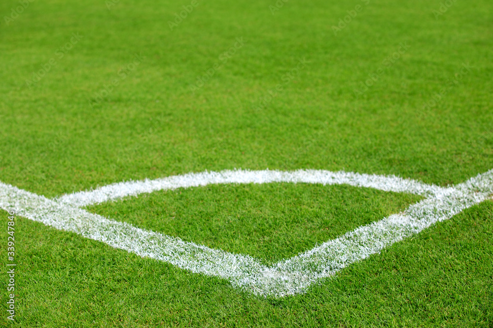 conner line on green grass of football field