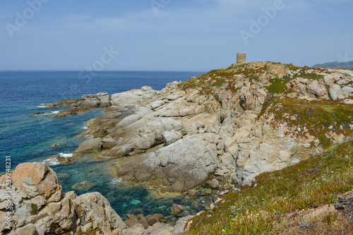Genoese tower at Punta Spano amongst the maquis and rocks, Balagne region of Corsica, France