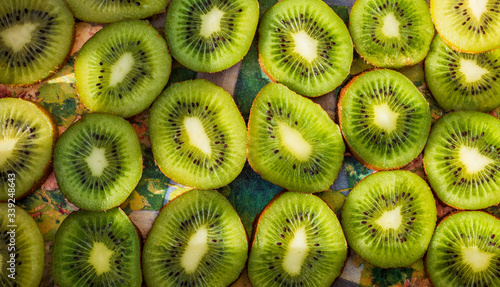 Fresh and ripe slices of kiwi fruit, summer wallpaper background.