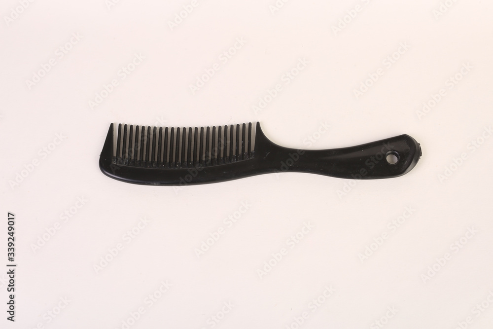 a black comb on an all white back ground a black comb on an all white back ground