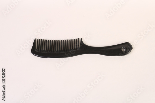 a black comb on an all white back ground