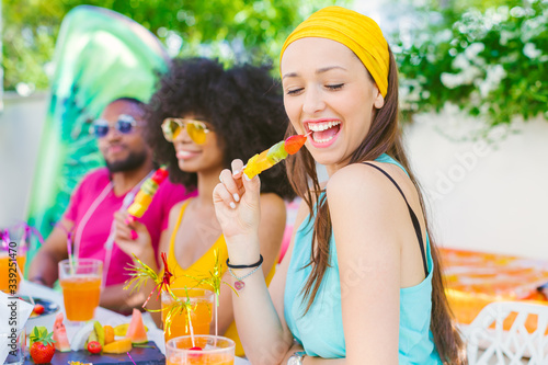 Canvas Print Mixed race group of friends having fun -millennials eating and drinking together