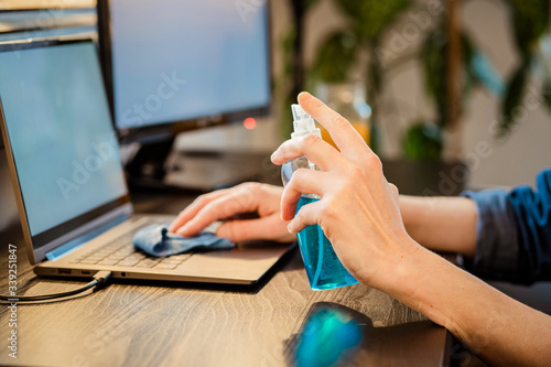 Obraz na płótnie sanitizing computer or laptop keyboard coronavirus protection