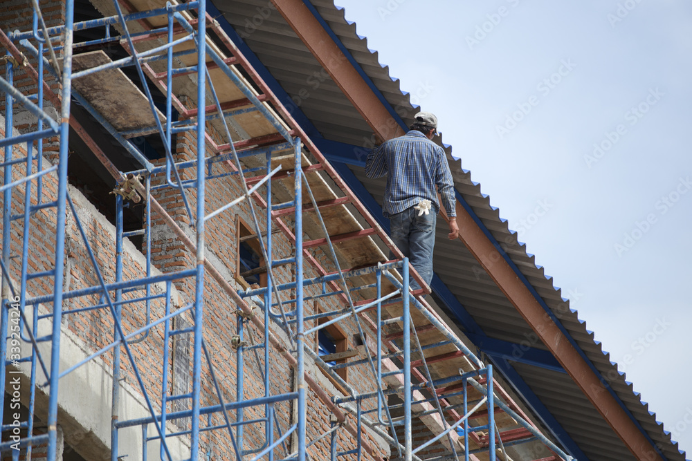 construction worker is   walking on temporary  scaffolding not safe