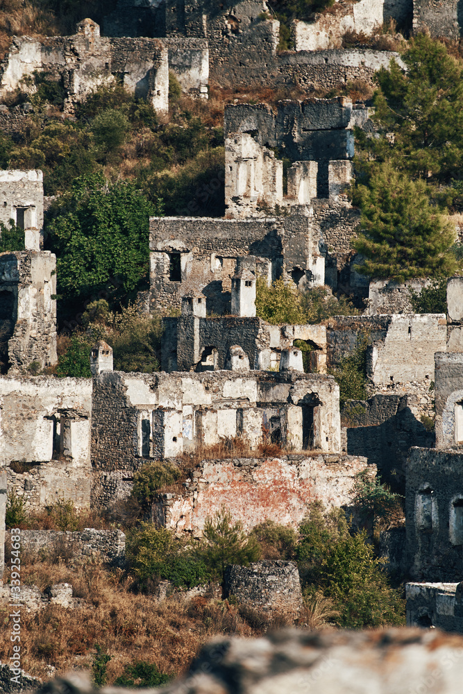 The abandoned Greek village of Kayakoy, Fethiye, Turkey. Ghost Town Kayakoy. Turkey, evening sun. Ancient abandoned buildings of rock and stone.