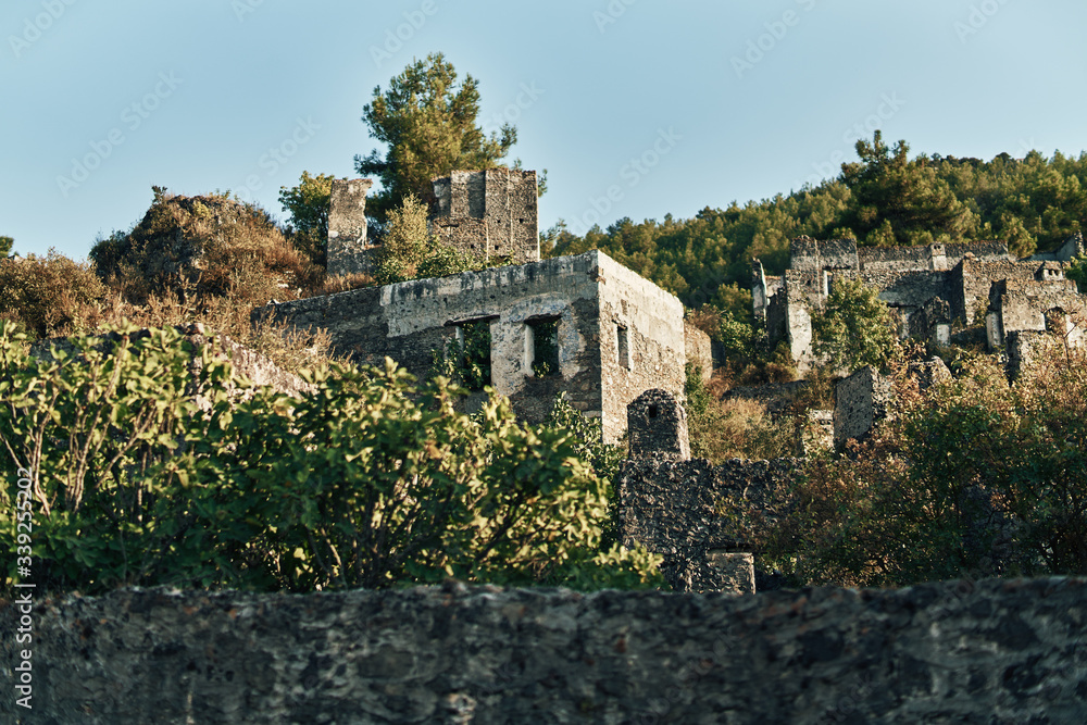 The abandoned Greek village of Kayakoy, Fethiye, Turkey. Ghost Town Kayakoy. Turkey, evening sun. Ancient abandoned buildings of rock and stone.