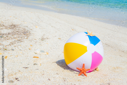 Beach ball and star fish on the sand