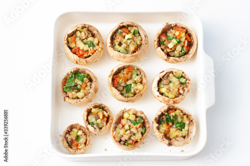 Stuffed mushrooms with vegetables in a white baking dish