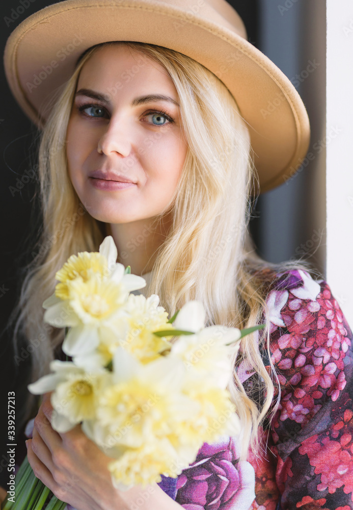 woman in dress with a bouquet of daffodils in hands woman in dress with a bouquet of daffodils in hands