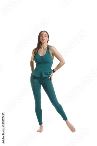 Slender athletic girl in green sportswear Isolated on a white background.
