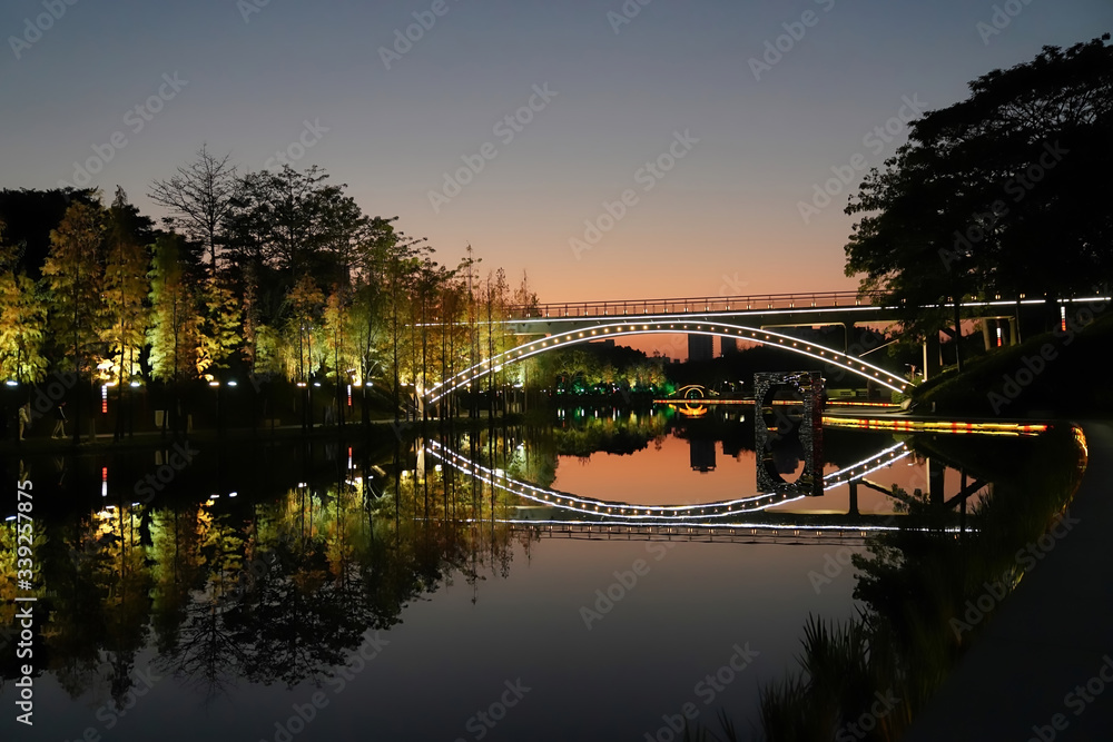 Beautiful bridge over the pond in the park, at sunset