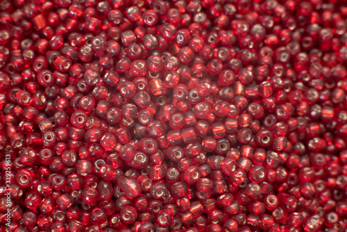 A bunch of traslucent red 8 0 seed beads