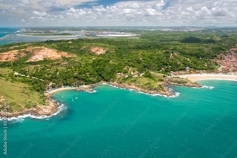 Calhetas beach, near Recife, Pernambuco, Brazil on March 1, 2014. Aerial view showing the proximity to the port of Suape in the background