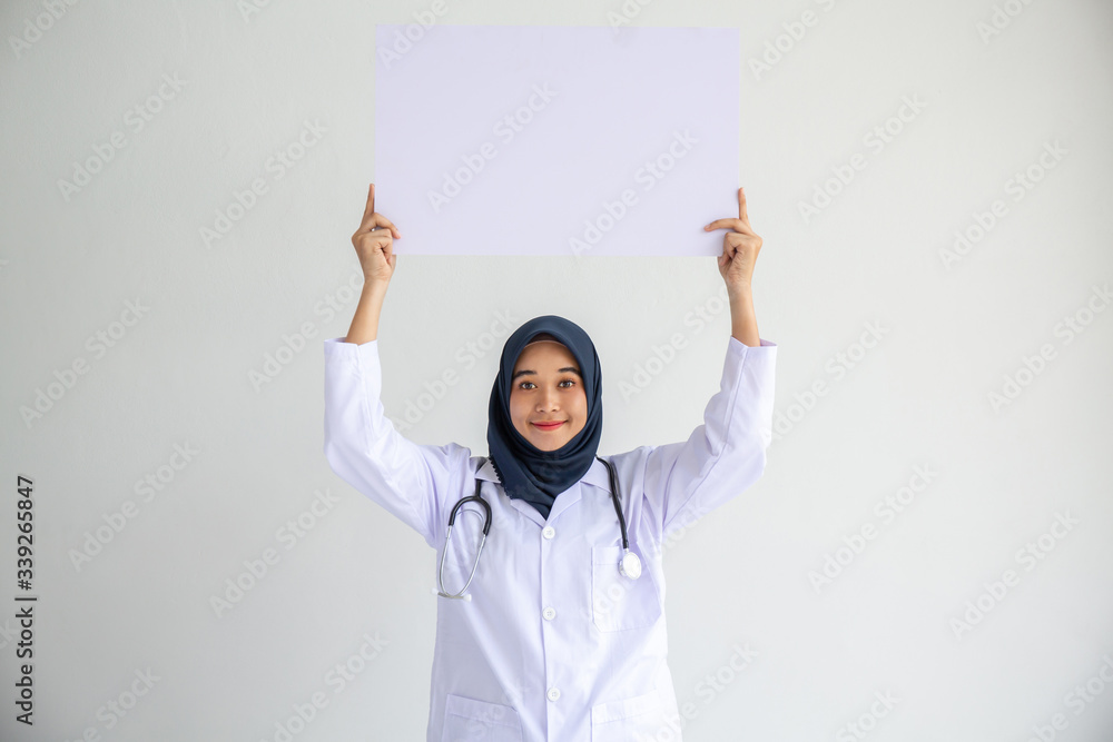 Young Arab Muslim doctor women smile showing on isolate card white background concept for Islam people working in medical hospital health care, Modern Nurse wear hijab in pandemic business service. Young Arab Muslim doctor women smile showing on isolate card white background concept for Islam people working in medical hospital health care, Modern Nurse wear hijab in pandemic business service.