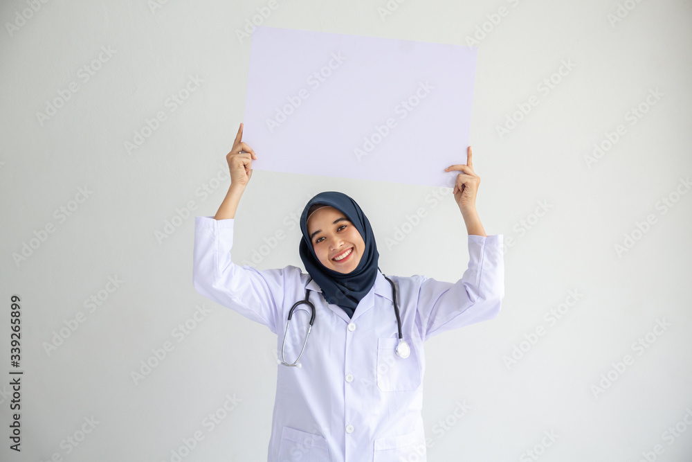 Young Arab Muslim doctor women smile showing on isolate card white background concept for Islam people working in medical hospital health care, Modern Nurse wear hijab in pandemic business service. Young Arab Muslim doctor women smile showing on isolate card white background concept for Islam people working in medical hospital health care, Modern Nurse wear hijab in pandemic business service.