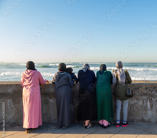 Five women and a child watching the sea in Casablanca, Morocco