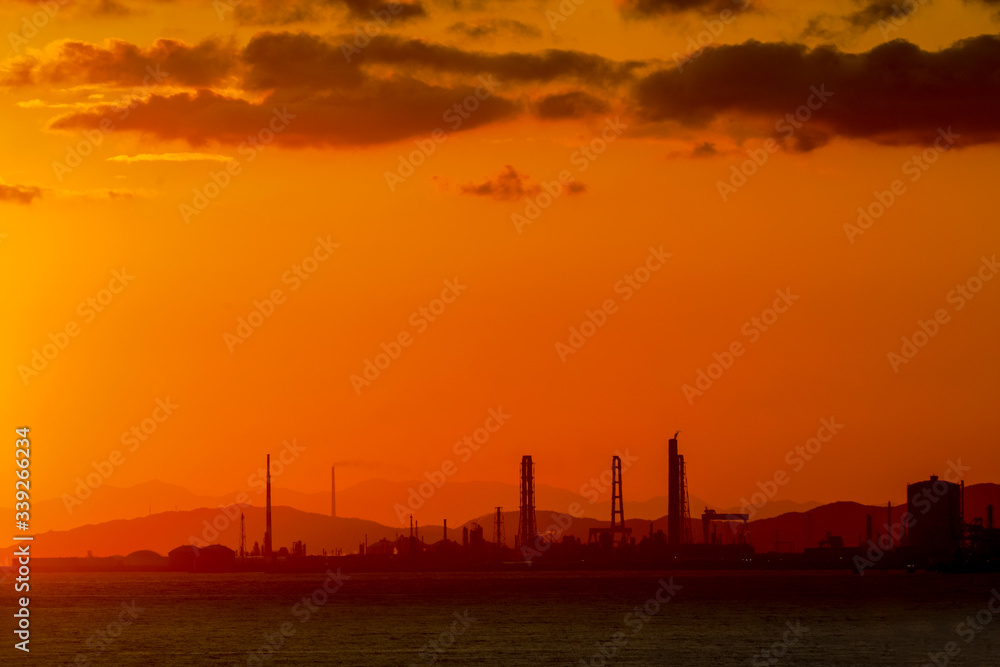 sunrise on sea beach at industrial city in Japan