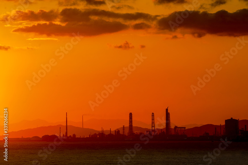 sunrise on sea beach at industrial city in Japan © suchatbky