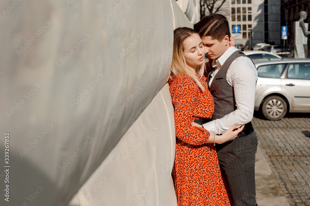 Concept of love relationships man and woman. Lovely couple walking in the big city, hugging, kissing and enjoying each other. Concept of love relationships man and woman. Lovely couple walking in the big city, hugging, kissing and enjoying each other.