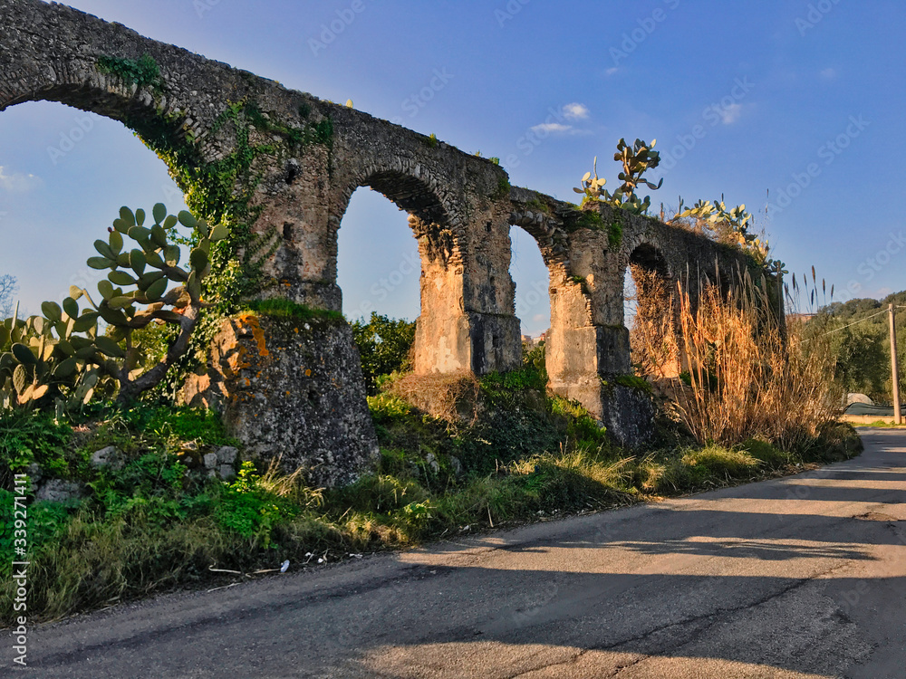 Arches of an ancient aqueduct that supplied a mill, Italy.