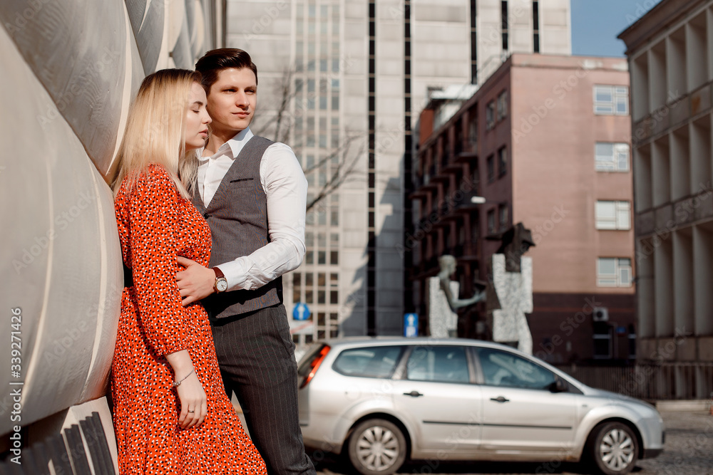 Concept of love relationships man and woman. Lovely couple walking in the big city, hugging, kissing and enjoying each other. Concept of love relationships man and woman. Lovely couple walking in the big city, hugging, kissing and enjoying each other.