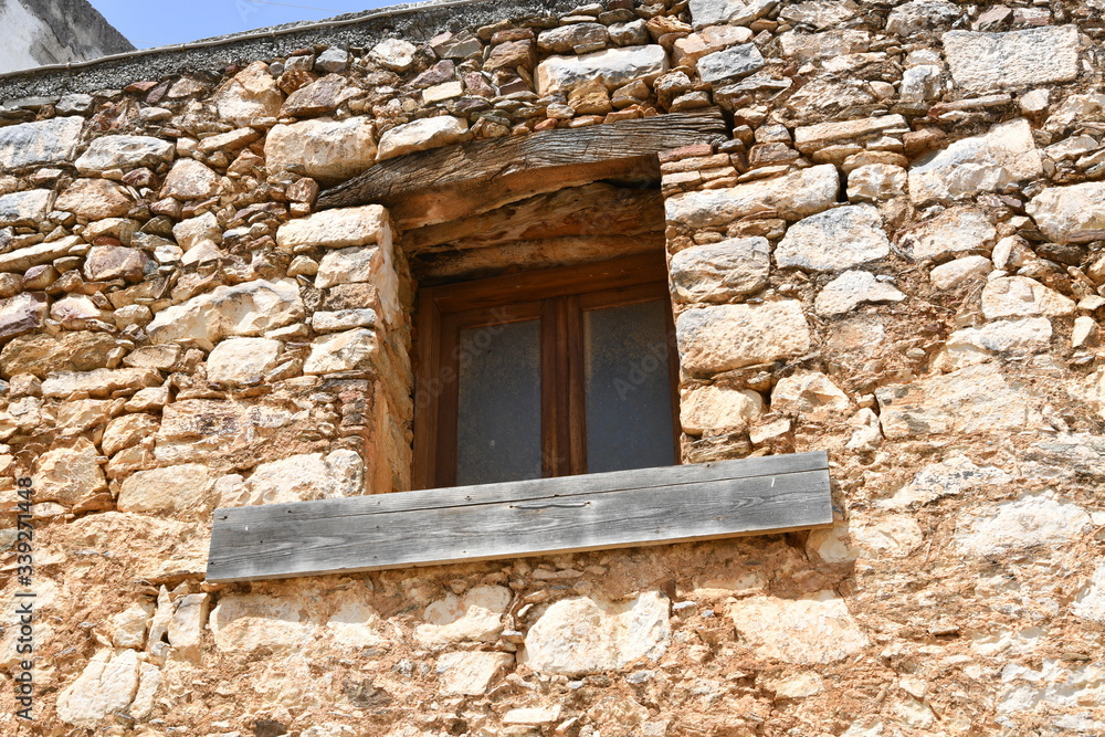 antique window of an old house with an old mediterranean village