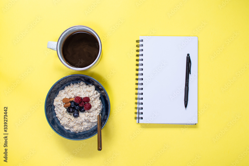 notepad with coffee and oatmeal blueberry banana bowl ready to start the day notepad with coffee and oatmeal blueberry banana bowl ready to start the day