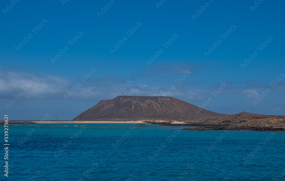 Canary islands white sand beach on Fuerteventura small island Isla de Lobos and Lanzarote in the background in october 2019