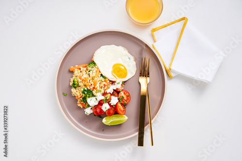 Healthy dish with spelt, goat cheese, tomatoes and egg