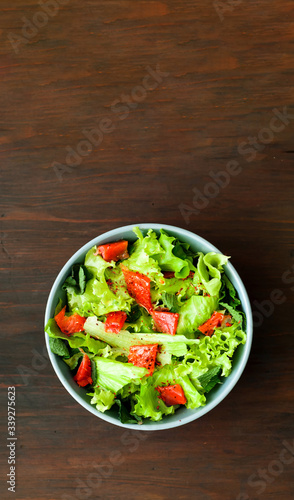 Salmon Poke Salad on wooden background. Slow food concept or healthy eating. Close-up