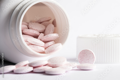 Melatonin Tablets Spilled from a Bottle photo