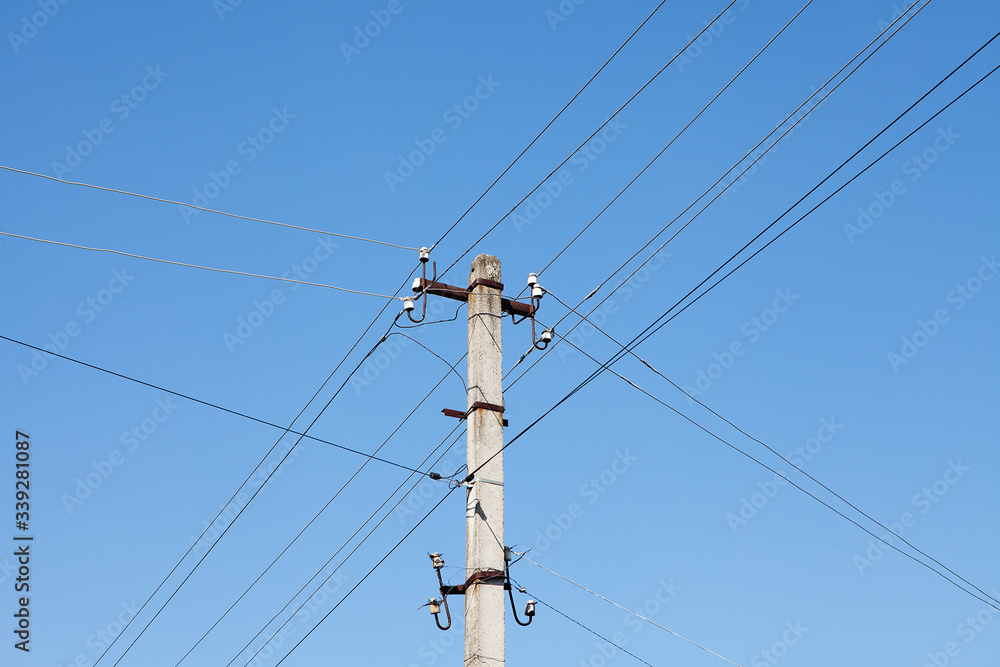 Electric pole with electric wires on blue sky Electric pole with electric wires on blue sky