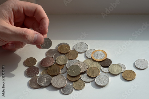 A man counts money and divides it. Round coins. 