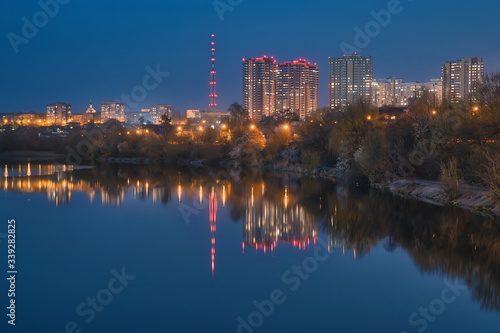 Urban landscape  view to residential quarters reflecting in calm water. Kharkiv  Ukraine