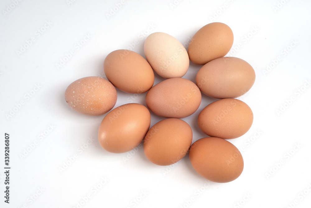 a dozen chicken eggs on a white background. view from above a dozen chicken eggs on a white background. view from above