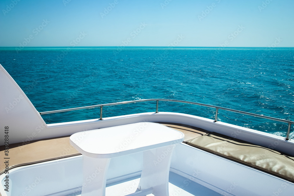 A Yacht at sea table on the deck Rest in a ship for vip persons on water background.
