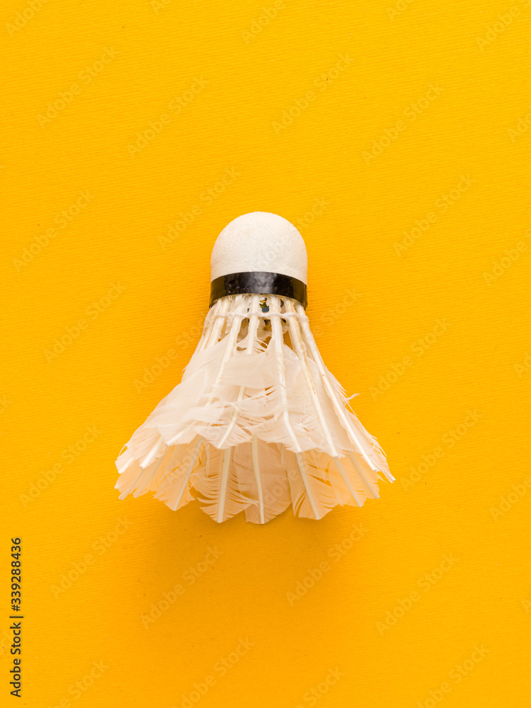 White Feather Shuttlecock with yellow a colour background stock isolated image. 