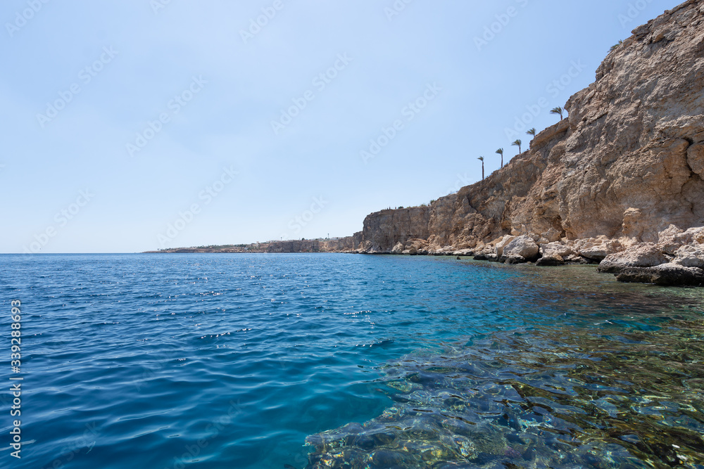 Sharm el Sheikh red sea coastline. Beautiful coral coast. Blue sky with clouds. Background texture