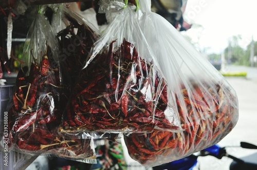 Photo Dry Red Chilies Hanging In Plastic At Store