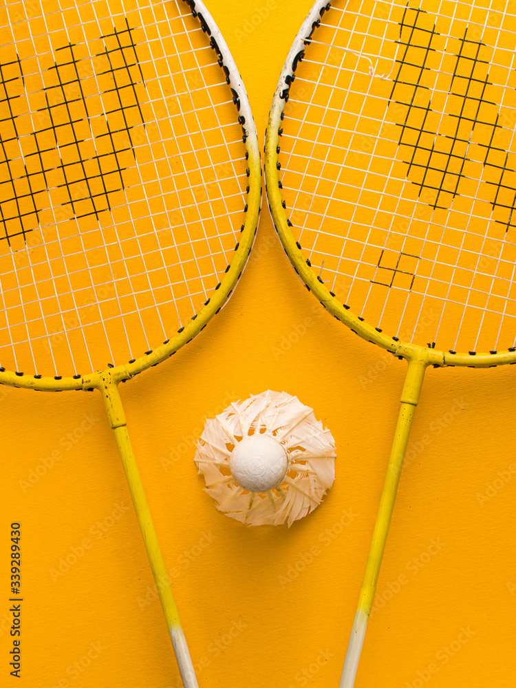 Badminton racket and White Feather Shuttlecock with a yellow colour ...