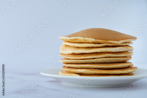 breakfast, pancakes on a white plate on a marble background