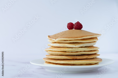breakfast, pancakes with raspberry on a white plate 
