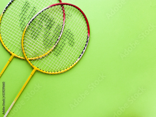 Badminton racket  with a green colour  background stock isolated image. 